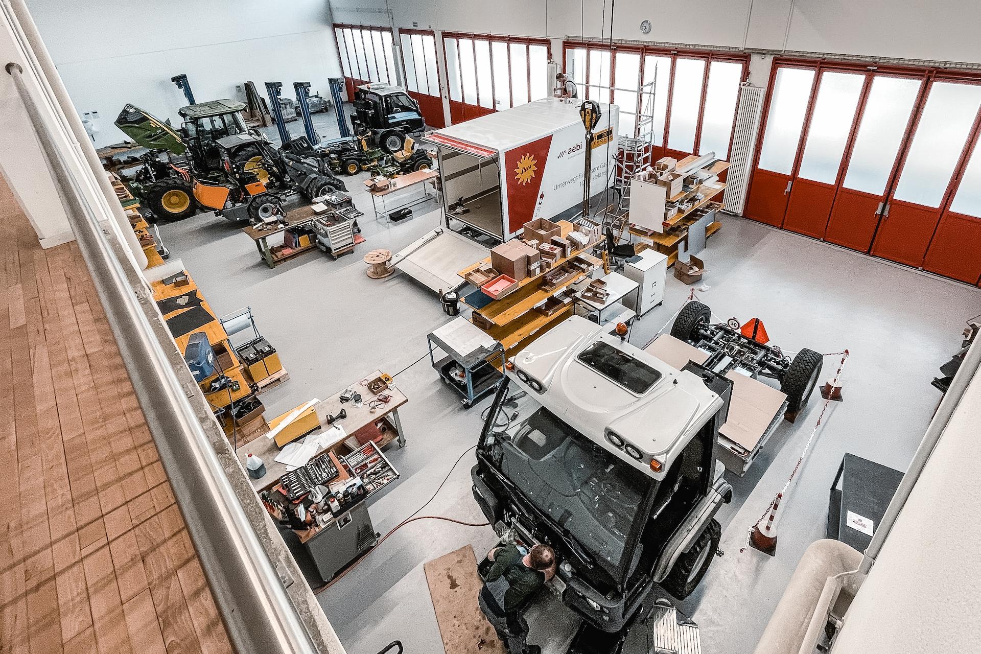 Blick in die Fahrzeugumbauhalle von ecovolta: Elektro-Umbauten und Batterieintegration in der Werkstatt